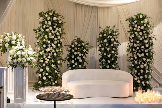 White floral stage with lounge seating